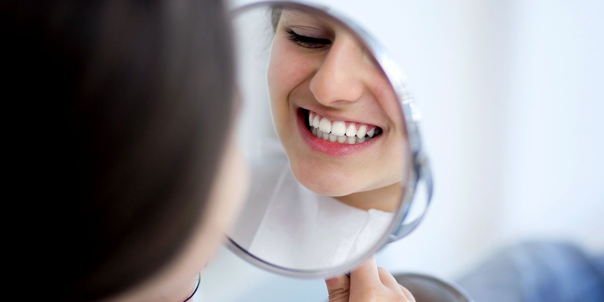 Braces Care Girl Smiling in the Mirror