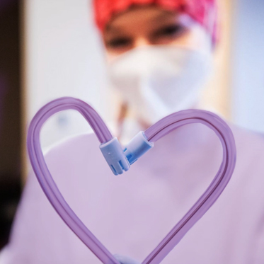 Decorative Image of Team Member Making Heart with Tubing Image